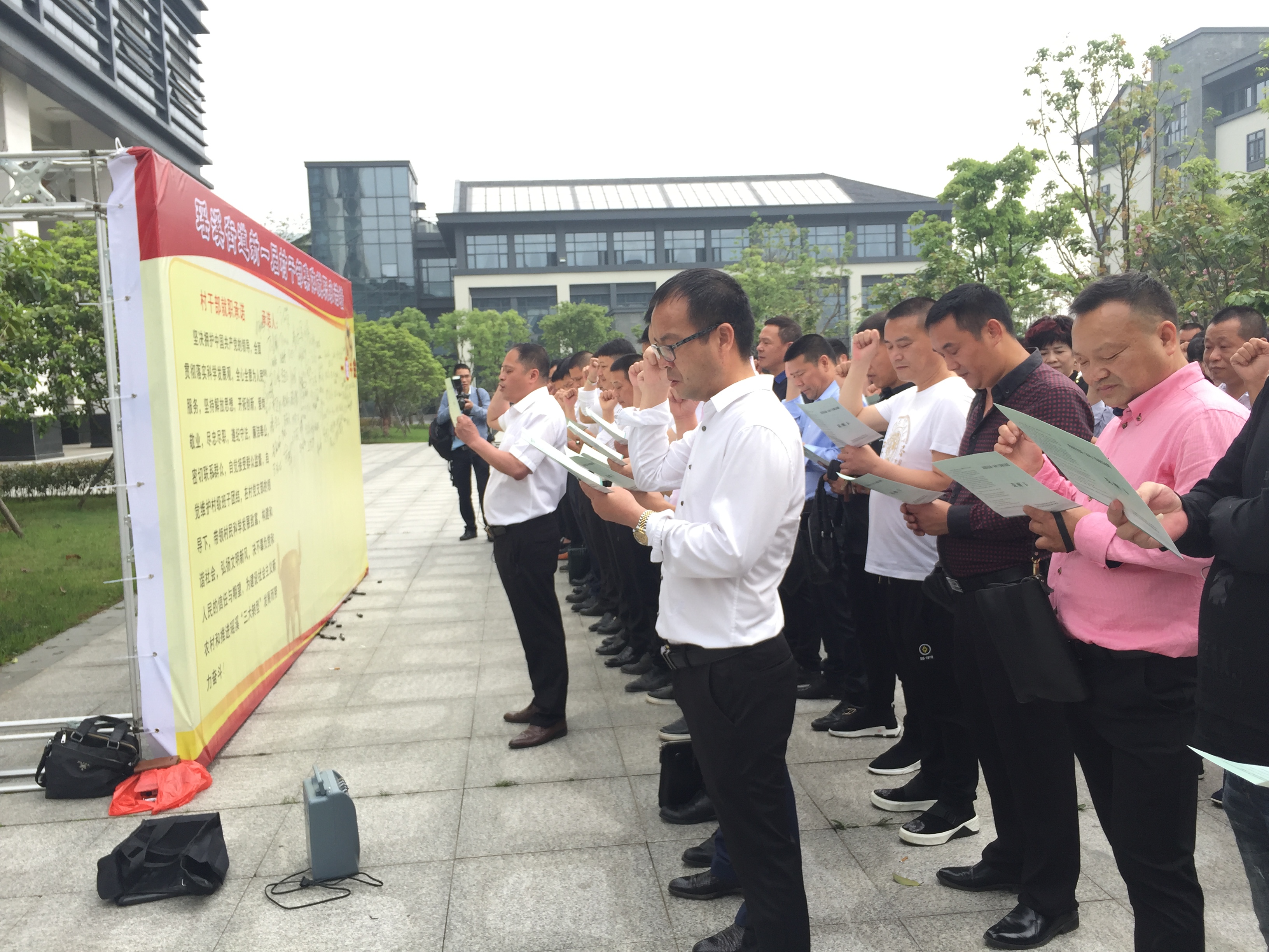 在集體就職承諾墻前，全體參訓村干部莊嚴的就職宣誓.jpg